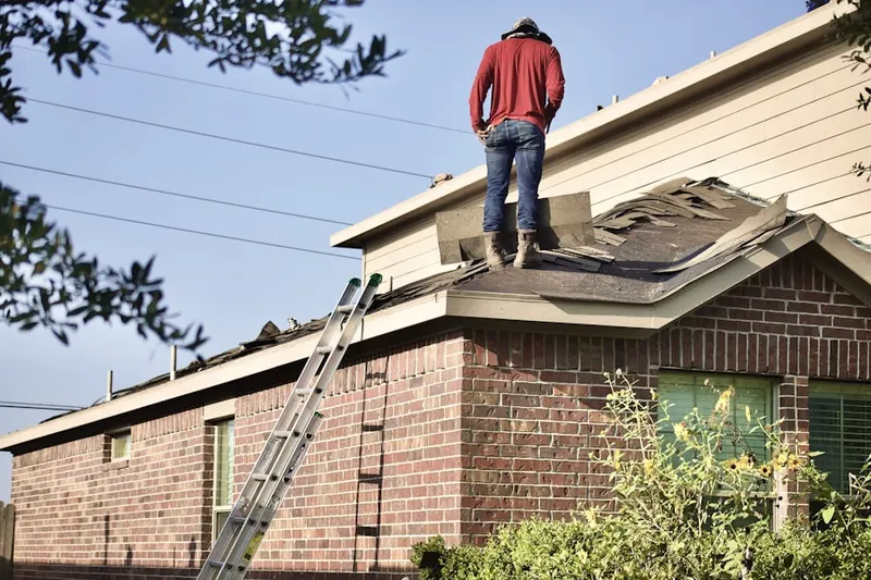 Professional roofer working on a residential roof in Waukee